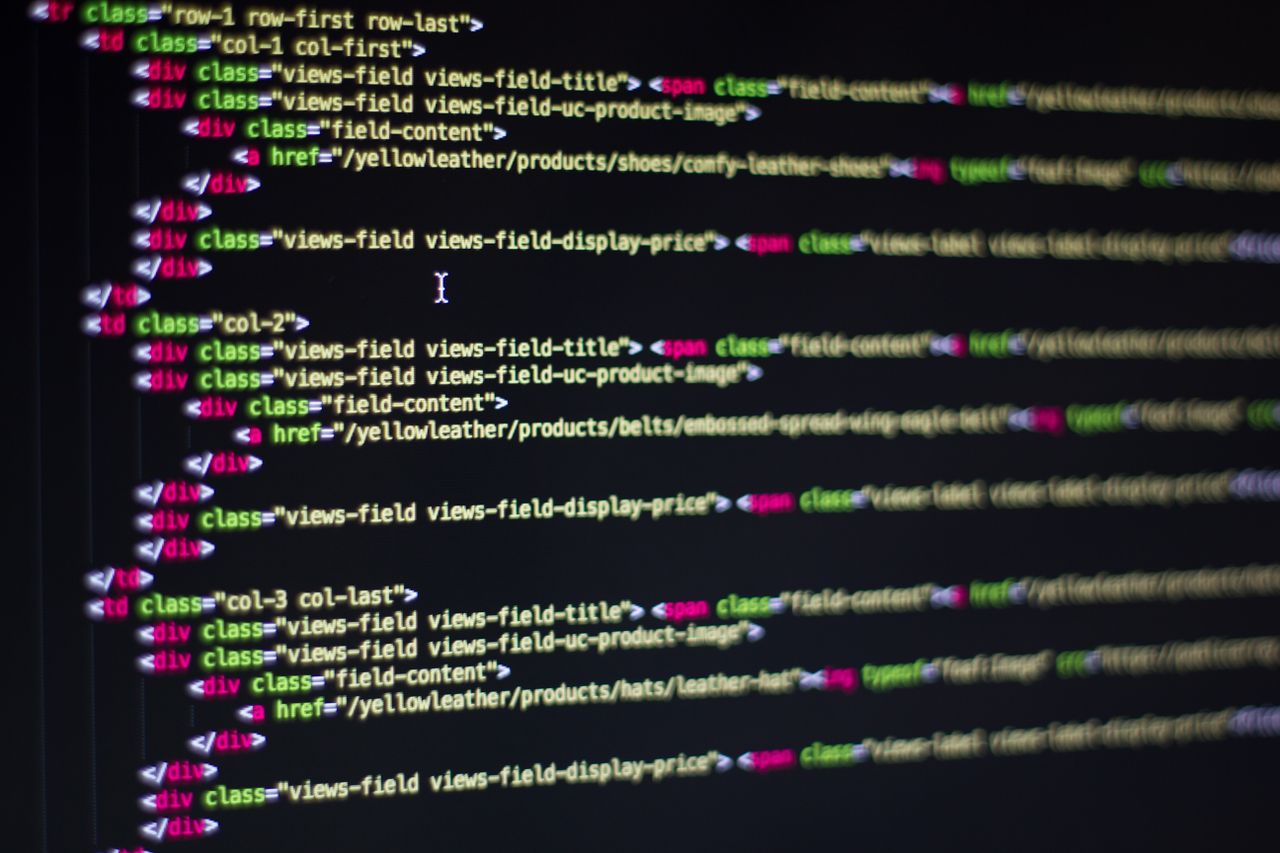 services-01 Detailed close-up of HTML code on a computer monitor, showcasing web development.